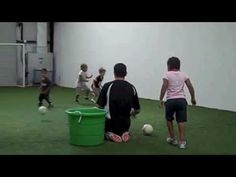 children are playing soccer in an indoor facility