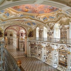 an elaborately decorated library with many bookshelves