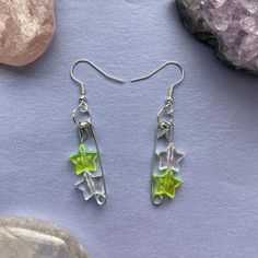 Green and White / Clear Star Safety Pin Earrings! ⭐️🧷 🦋 Silver safety pins with light green and white translucent/iridescent coloured stars :) handmade and great quality! ❗️CUSTOMS AVAILABLE: I can make customs of these earrings in any combination of the coloured stars in different colours, just message me!  🌿 Safety pin: approx 3cm long Whole earring: approx 5.5cm long 🌙 Postage is £1.20, 2nd class Green Star Earrings For Pierced Ears, Green Star-shaped Party Jewelry, Green Star-shaped Handmade Jewelry, Handmade Green Star-shaped Jewelry, Pin Earrings, Safety Pin Earrings, Safety Pins, Howls Moving Castle, Safety Pin