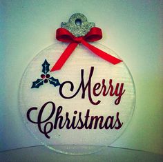 a merry christmas ornament hanging on a wall