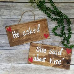 two wooden signs that say he asked she said about time