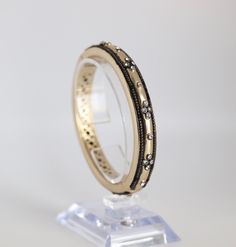 This Matt Gold Bangle is 10mm wide and has a magnetic clasp. The channel-set cubic zirconia stones are embedded in the bangle, and the antique edge adds a unique touch. Black Bracelets, Gold Bangle Bracelet, Gold Bangle, Channel Set, Magnetic Clasp, Tennis Bracelet, Gold Bangles, Bangle Bracelet, Bangle Bracelets