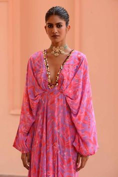 Lilac, pink kaftan with floral print and sequin embroidered neckline.
Components: 1
Pattern: Printed, Embroidery
Type Of Work: Floral
Neckline: Plunge V neck
Sleeve Type: Kaftan sleeves
Fabric: Crepe
Color: Purple,Pink
Other Details: 
Gathered waistband
Occasion: Resort - Aza Fashions Bollywood Style V-neck Party Kaftan, Traditional V-neck Sequin Dress, Bollywood Style Sequined V-neck Dress, Bollywood V-neck Sequin Dress, Bollywood Style Embellished V-neck Kaftan, Eid Mirror Work V-neck Dress, Designer V-neck Kaftan With Mirror Work, Floral Print V-neck Kaftan For Party, Anarkali Kaftan With Mirror Work And V-neck