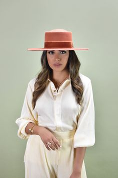 With all the flair of a classic boater hat, this handcrafted piece makes a striking presentation with a new dipped crown style. It's fashioned in smooth 100% pure Australian wool, and embellished with an elegant velvet bow. Designed with an adjustable inner band to customize and adjust to the perfect fit! Be sure to check out all our unique hat and beret styles! Details: 100% Australian wool Spot / specialist clean Style & Fit: Brim: 8.5 cm Head circumference: Small/Medium - 57cm, Medium/Lar Classic Boater Hat With Flat Crown For Fall, Chic Flat Brim Top Hat For Fall, Chic Fall Top Hat With Flat Brim, Elegant Flat Crown Top Hat For Fall, Classic Flat Crown Felt Hat For Spring, Classic Spring Felt Hat With Flat Crown, Spring Classic Felt Hat With Flat Crown, Classic Solid Color Boater Hat For Spring, Chic Fedora With Flat Crown For Spring