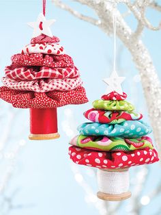 two christmas tree ornaments hanging from branches