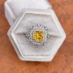 Estate 18KT white gold cut-corners yellow diamond + pave white diamond ring. Features a split shank with diamonds half way down. Pave, round diamonds center the modified yellow fancy, faceted, cushion diamond. Interesting undercarriage with scalloped diamonds. This an absolutely lovely attention getting piece with lots of intricate design. Size 6.25 Can be resized for an additional fee 1.64 CT Fancy Yellow Diamond Set in yellow gold, with prong set halo diamonds Then cluster of diamonds set in w Yellow Diamond Cut Platinum Ring, Yellow Platinum Diamond Ring With Diamond Cut, Yellow Diamond Ring With Center Stone, Yellow Platinum Diamond Ring Fine Jewelry, Dazzling Yellow Diamond Ring With Accents, Fine Jewelry Yellow Diamond Platinum Ring, Yellow Platinum Diamond Ring, Platinum Rings With Yellow Diamond Accents, Yellow Platinum Rings With Diamond Accents