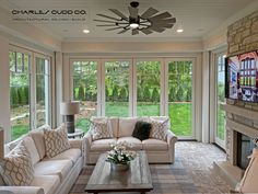 a living room filled with furniture and windows