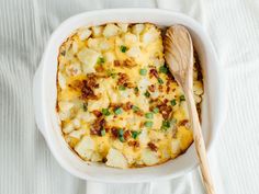 a casserole dish with potatoes and green onions