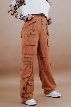 Our Mineral Washed Cargo Pants. These vintage-inspired pants offer both style and comfort. Their unique mineral-washed finish gives them an eclectic, on-trend look. Mineral Washed pants Cargo pockets Pair them with colorblock tops for a trendy, boho-inspired outfit Imported Relaxed Fit Bigger waistline Size down Fabric: 100% Cotton Measurements: S: RISE: 11" INSEAM: 32"M: RISE: 11.5" INSEAM: 32"L: RISE: 11.5" INSEAM: 32" XL: RISE: 12" INSEAM: 32" Model Specs: Karli is wearing a size small in the Pants Cargo, Everyday Chic, Color Block Top, Trendy Boho, Rust Orange, Casual Chic Style, Retro Aesthetic, Chic Boutique, Small Shop