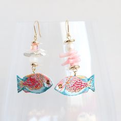 These tropical fish earrings look unique, they are full handmade and embroidered. There is used rhinestone Swarovski beads, natural pearl, glass and coral beads. Cute earrings can be a great gift for ocean lovers.  The earrings are super lightweight and comfortable for full day wearing. Pink and blue fish looks perfectly with a lot of outfits.  Embroidered jewelry is always about unique design and individuality.  I often get the feedback that the photo doesn't show how they are gorgeous, because Coral Beaded Earrings For Gifts, Handmade Ocean-inspired Pearl Earrings For Gift, Handmade Pearl Earrings For Summer, Fish Earrings, Embroidered Jewelry, Beads Embroidery, Swarovski Beads, Blue Fish, Pink Paper