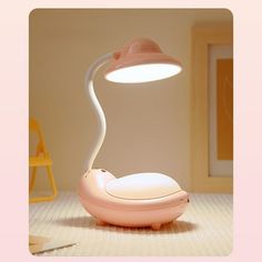 a pink lamp sitting on top of a table