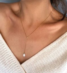 "This dainty sterling silver necklace is made of single genuine Freshwater Pearl and it is perfect for layering. Simple yet feminine Y necklace will go with everything and will be beautifully layered with your other favorite necklaces. This listing is only for the Y necklace, you can find 5 tiny Pearls layering necklace here: https://etsy.me/3wnTcB6 ● MATERIAL:High quality 925k Sterling Silver on chains (Hypoallergenic) 3 material options (Sterling Silver 925k, 22k Gold Fill or 22k Rose Gold Fil Y Necklace Gold, Pearl Drop Necklace, Single Pearl, Y Necklace, Rainbow Bracelet, Chakra Jewelry, Protection Bracelet, Pearl Diamond, Lariat Necklace