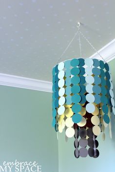 a chandelier hanging from the ceiling in a room with polka dots on it