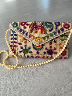 Indian handmade boho style handbag . hand embroidery all over . use as clutch bag or cross body . very lightweight Bohemian Rectangular Bag For Spring, Trendy Embroidered Beige Shoulder Bag, Trendy Beige Embroidered Shoulder Bag, Bohemian Satchel For Summer, Embroidered Beige Satchel For Everyday Use, Spring Pouch Bag, Trendy Embroidered Beige Bag, Bohemian Style Summer Satchel, Summer Mobile Phone Bag