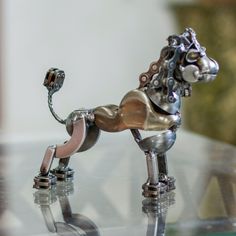 a metal horse on top of a glass table