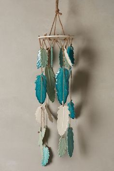 a white and blue dream catcher hanging from a rope