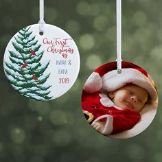 two christmas ornament hanging from a tree with a baby's photo on it