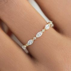 a woman's hand with a diamond ring on it