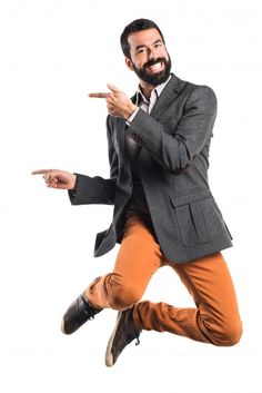 a man is jumping in the air while wearing an orange pants and a gray jacket