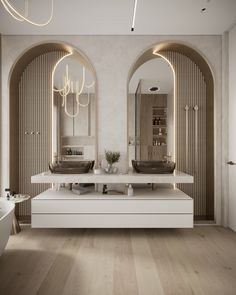 a bathroom with two sinks and mirrors in the middle of it's walls, along with an arched doorway leading to another room