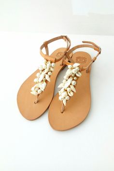 Beach wedding Pearl sandals, Cowrie sandals, Bridal sandals, Sea shell sandals, Wedding sandals, Beach wedding flats, Bridal party shoes, Summer shoes This pair is made of genuine Greek leather and is decorated with  a gilded chain, cowrie shells and pearls  Elegant leather sandals, a must have accessory for the summer. They could be perfect for any woman who wants to make a difference & wear something special every day. *All sandals are made of Genuine Greek Leather! *You'll receive it in a han Elegant T-strap Sandals With Flat Heel For Vacation, Elegant Flat Heel Sandals For Beach Season, Elegant Round Toe Sandals For Beach Season, Elegant Ankle Strap Sandals For Vacation, Party Sandals With Single Toe Strap For Beach Season, Elegant Slingback Sandals For Summer Beach, Elegant Closed Toe Slingback Beach Sandals, Elegant Flat Sandals For Beach Season, Elegant Closed Toe Slingback Sandals For Beach