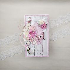 a card with lace and flowers on it