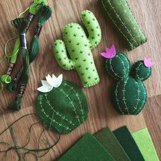 felt cactuses and other crafting supplies laid out on a table