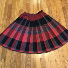 This is an awesome colorful mid length pleated plaid skirt! Made in a soft lightweight wool and woven fabric in the classic plaid design. The colors are still brilliant and blended in shades of red, gray, and black. It's a great find and so wearable! The waistband has a button closure and vintage metal zipper. No labels. Fantastic vintage condition with no issues Again, no labels available but it has an obviously small waistband and generous , full skirt. Please as always refer to the measuremen Plaid Flared Pleated Lined Skirt, Plaid Flared Pleated Skirt With Lining, Scottish Style Plaid Skirt For Fall, Scottish Plaid Skirt For Fall, Scottish Red Skirt For Fall, Fall Scottish Plaid Skirt, Retro Plaid Pleated Skirt For Fall, Fall Plaid Pleated Flared Skirt, Red Pleated Lined Skirt For Fall