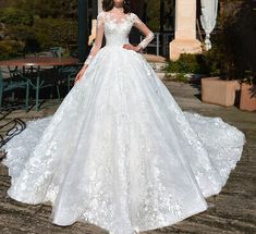 a woman in a white wedding dress standing outside