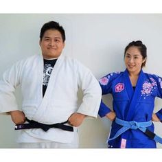 two people standing next to each other with their hands on their hipss and one person wearing a blue kimono