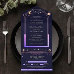 a purple and black wedding card on top of a plate with silverware next to it