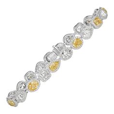 This superb diamond bracelet showcases an exquisite fringe of fancy yellow and white cushion, oval, round and pear shaped diamonds. They are each complimented by a dainty micro pavé halo. The diamonds total 10.00ct in weight and are graded at E-F, Fancy Yellow in color, VS1-VS2 in clarity. Yellow Diamond Bracelet, Mark Broumand, White Cushions, Pear Shaped Diamond, Yellow Diamond, Micro Pave, White Diamond, Pear Shaped, Pandora Charm Bracelet