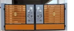 an orange and black gate with flowers on it