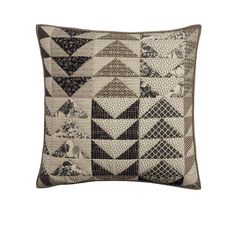 a black and white patchwork pillow on a white background with an image of triangles