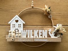 a wooden sign that says wilken with a house on it