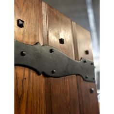 an old wooden door with metal rivets on it