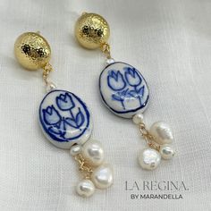 “La Regina” ( The Queen ) earrings – a regal blend of hand-painted ceramic tulip beads, genuine pearls, and 24k plated earrings posts. Inspired by Sicilian culture, these bold earrings exude empowerment, embodying the essence of a queen. All my designs are inspired by my trips. Somehow, islands always captivate my heart. This time, the inspiration comes from the island of Sicily in Italy. Sicilian jewelry often reflects the island’s cultural heritage. It frequently incorporates traditional motif Elegant Hand Painted Gold Earrings, Elegant Hand Painted Teardrop Earrings, Sicilian Jewelry, Sicilian Culture, Ceramic Tulip, Tulip Beads, Queen Earrings, Bold Earrings, Real Pearls