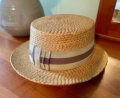 This is a really cool vintage boater straw hat with a olive green and brown ribbon and bow. The inside brim indicates this is from Warner's, Baltimore, Maryland. The other side of the brim shows Dobbs. There's also an indicator that shows this was made in Italy. There is no size indication, but I believe this may be a men's size 7.  This hat is sometimes referred to as a skimmer hat, Great Gatsby hat, or some people call them Downtown Abby hats. Regardless, I love these hats and this one is a nice one. There's some wear and tear from age and use. Specifically, some small damage to the topside of the back.I tried to show the overall condition in my photos.  Thanks for checking out my shop. I hope you enjoy this, and the many other great vintage goods I have. All my items are actual vintage, Vintage Brown Panama Hat For Vacation, Brown Vintage Panama Hat For Vacation, Handmade Vintage Hat Bands, Vintage Adjustable Boater Hat With Flat Crown, Vintage Adjustable Hat Bands For Vacation, Vintage Straw Boater Hat With Flat Brim, Vintage Straw Boater Hat With Short Brim, Vintage Straw Panama Hat For Kentucky Derby, Retro Fedora Straw Hat For Beach