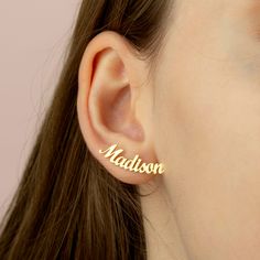 a close up of a person's ear with the word madison on it