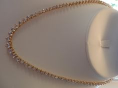 "ALL HANDMADE 14K SOLID YELLOW GOLD NECKLACE WITH 105 GRADUATED ALL NATURAL, MINED WHITE SAPPHIRES - NOT LAB CREATED. GUARANTEED. RECENTLY APPRAISED BY A GIA GRAD GEMOLOGIST. ABSOLUTELY STUNNING, WORN ONLY A HANDFUL OF TIMES. I AM THE SOLE OWNER. IT HAS A SECURE TONGUE CLASP CLOSURE & WRAP-AROUND CATCH THAT SNAPS SHUT TIGHTLY FOR ADDITIONAL SECURITY. Approximately 57 carats total of sapphires. Largest stone approx. 6 mm and smallest approx. 2.5mm. VS clarity. Total gram weight for the neckla Formal 14k Yellow Gold Tennis Necklace, Yellow Gold Brilliant Cut Tennis Necklace For Wedding, Elegant Gold Single Strand Custom Necklace, Formal Gold Diamond Necklace Hallmarked, Elegant Gold Single Strand Necklace, Gold Single Strand Necklace For Formal Occasions, Formal Gold Single Strand Necklace, Gold Custom Necklace With 17 Jewels For Formal Occasions, Gold Single Strand Bridal Necklace For Formal Occasions