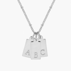 Initial pendants make such special statements, and our Madeline Rectangle Three Initial Pendant is one of our faves. Choose three initials to add to our petite disc necklace. Makes the perfect gift for your fave momma or BFF. 1/2" x 1/4" gold filled or sterling silver tag Hand stamped initial 16" brass satellite chain with 2" extender Lobster claw closure Made in the USA With customization this item is FINAL SALE NOTE - discs DO NOT slide on and off the chain. If you are looking to add or remove Minimalist Initial Necklace With Charms For Mother's Day, Modern Everyday Initial Pendant Charm Necklace, Modern Initial Pendant Charm Necklace For Everyday Wear, Modern Everyday Charm Necklaces With Initial Pendant, Classic Rectangular Charm Necklaces For Everyday, Minimalist Square Pendant Initial Necklace, Minimalist Everyday Initial Necklace With Square Pendant, Classic Initial Necklace With Charms For Everyday, Mother's Day Initials Charm Necklace