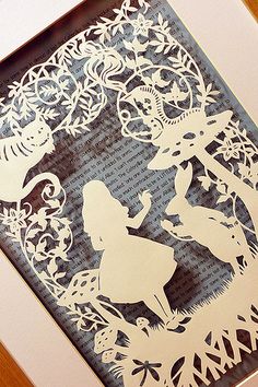 the silhouettes of two children are in front of an intricate paper cutout design