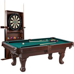 a pool table with a dart and two cues in front of a wall mounted clock