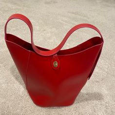 Brand New Without Tags Elizabeth Arden Red Vegan Leather Bucket Bag Single Shoulder Strap And A Flap And Gold Twist Closure. 14” Tall X 12” Wide. Strap 20” Long Red Rectangular Bucket Bag With Large Capacity, Red Rectangular Large Capacity Bucket Bag, Red Large Capacity Rectangular Bucket Bag, Red Rectangular Hobo Bag With Large Capacity, Trendy Red Bucket Bag With Large Capacity, Red Bucket Bag With Large Capacity For Daily Use, Red Large Capacity Bucket Bag For Daily Use, Large Capacity Red Rectangular Hobo Bag, Red Leather Bucket Bag With Large Capacity