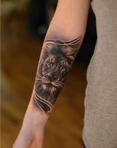 a man with a lion tattoo on his arm