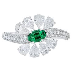 Elegant and exquisitely detailed 18 Karat White Gold Ring, center set with 0.42Cts .Oval Shape Emerald and micro pave set Diamonds, weighing approx. 2.05Cts Beautifully Hand crafted in 18 Karat White Gold. Stone Detail: Emerald: 6x4MM Stone Weight: Emerald: 0.42cts Diamond: GH/SI Total Diamond Weight: 2.05Cts Note: Currently Available in US Ring Size -7, Custom Ring Size Available on Request Emerald Diamond Ring, Blue Chalcedony, White Gold Ring, Emerald Cut Diamonds, Jewelry Ring, Micro Pave, Diamond Studs, Custom Rings, White Gold Rings