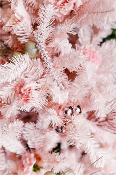 a pink christmas tree with ornaments on it