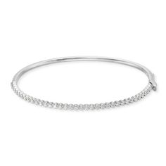 This exquisite bangle features a total carat weight of 1.00, displaying brilliant round diamonds in a single prong setting allowing the diamonds to float gracefully across the wrist. It is the perfect piece to wear alone or as a stack. Diamond Bangle With Pave Setting, White Round Bangle With Pave Setting, Diamond White Bangle With Pave Setting, Classic White Gold Cuff Bracelet With Single Cut Diamonds, Diamond White Diamond Bangle With Pave Setting, Modern Diamond Bracelet With Prong Setting, Diamond White Cuff Bracelet With Diamond Accents, Modern White Gold Diamond Bangle With Diamond Accents, Modern White Gold Diamond Bracelet With Accents