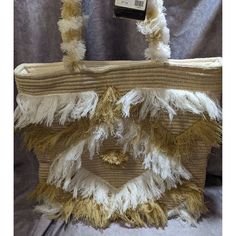 America & Beyond Fringed Shoulder Bag. 17.5 X 16 X 5 Inches. 11.5 Inch Drop. Cream Exterior With White And Tan Fringe Details. Fringe Detailed Straps. White Interior Lining. Snap Closure. 2 Interior Open Pockets. 1 Interior Zip Pocket. 100% Cotton. New With Tags! Beautiful Bohemian Style Fringed Shoulder Bag By America & Beyond. It's Brand New With Tags, And Has Never Been Used. It's Made Of 100% Cotton, And Has Unique And Fun Fringe Details. Perfect As An Every Day Bag, For Festivals, Going Out White Fringe Travel Bag, White Rectangular Bag With Fringe, White Fringed Bag For Summer, White Rectangular Fringe Bag, White Fringed Shoulder Bag For Beach, White Beach Shoulder Bag For Shopping, White Shoulder Beach Bag For Shopping, Elegant White Beach Bag With Braided Handles, White Straw Shoulder Bag For Shopping