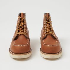 Crafted using the original No. 23 last, developed in the 1950’s, the 6” Moc Toe has become one of the most iconic work boots in the game. Still very much unchanged in all that time, this classic boot is still made in America, and features a traction tread sole, Goodyear welted construction, and a Puritan triple stitch. This full-grain oiled leather is known as the original Red Wing leather, dubbed ‘Oro Legacy’. This leather softens over time whilst maintaining its durable structure, and develops Winter Work Wear, Moc Toe Boots, Red Wing Shoes, Wing Shoes, Red Wing, Toe Boots, Classic Boots, Leather Conditioner, Winter Essentials